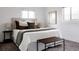 Bedroom with a comfy bed, decorative pillows, bench seat, and soft natural light at 1200 S Patton Ct, Denver, CO 80219