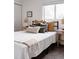 Inviting bedroom with a comfortable bed, decorative pillows, and warm lighting at 1200 S Patton Ct, Denver, CO 80219