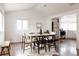 Open floor plan featuring a dining area with a wood table and a view into the kitchen at 1200 S Patton Ct, Denver, CO 80219