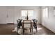 Bright dining room with hardwood floors and a light wood table surrounded by six chairs at 1200 S Patton Ct, Denver, CO 80219