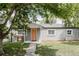 Attractive single-story home showcasing a gray exterior, a quaint front bench, and a neatly kept lawn at 1200 S Patton Ct, Denver, CO 80219