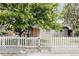 Charming home featuring a well-manicured lawn, a welcoming white picket fence and mature trees for added privacy at 1200 S Patton Ct, Denver, CO 80219