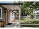 Cozy front porch featuring modern lighting, a stylish welcome mat, and a view of the meticulously maintained yard at 1200 S Patton Ct, Denver, CO 80219