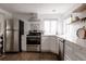 Bright kitchen with stainless steel appliances, white subway tile, and light countertops at 1200 S Patton Ct, Denver, CO 80219
