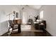 Bright living room featuring hardwood floors, a modern furniture set, and minimalist decor at 1200 S Patton Ct, Denver, CO 80219