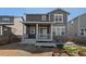 Back exterior of two-story home with a charming covered patio and grey wood and stone accents at 455 N Old Hammer St, Aurora, CO 80018