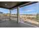 Covered back porch providing relaxing outdoor living space with backyard views at 455 N Old Hammer St, Aurora, CO 80018