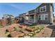 Backyard view, showing a stone patio, lawn and raised garden beds at 455 N Old Hammer St, Aurora, CO 80018