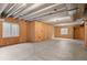 Unfinished basement with exposed ceiling beams, concrete floors, and natural light from windows at 455 N Old Hammer St, Aurora, CO 80018