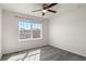 A bedroom with a ceiling fan and a large window overlooking the neighborhood at 455 N Old Hammer St, Aurora, CO 80018