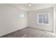 A bedroom featuring neutral walls and gray carpet, illuminated by natural light from two windows at 455 N Old Hammer St, Aurora, CO 80018