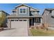 Two-story home featuring a stone facade and attached two car garage at 455 N Old Hammer St, Aurora, CO 80018