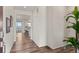 Inviting hallway with hardwood floors and neutral walls, flowing into a modern kitchen and dining area at 455 N Old Hammer St, Aurora, CO 80018