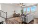 Bright living room featuring hardwood floors, large windows with lots of natural light, a ceiling fan, and stylish furniture at 455 N Old Hammer St, Aurora, CO 80018