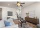 Cozy living room featuring a stylish sofa, decorative rug, a staircase, and modern decor at 455 N Old Hammer St, Aurora, CO 80018