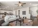 Spacious open-concept living room with hardwood floors, a comfortable sofa, and seamlessly connected to the kitchen and dining area at 455 N Old Hammer St, Aurora, CO 80018