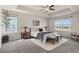 Relaxing main bedroom with tray ceiling, neutral tones, and large windows offering scenic views at 455 N Old Hammer St, Aurora, CO 80018