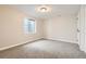Finished basement with neutral carpet, and an egress window for natural light and safety at 19383 E Chaffee Pl, Denver, CO 80249