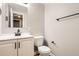 Bathroom features a modern vanity with black fixtures, and a toilet with towel bar at 19383 E Chaffee Pl, Denver, CO 80249