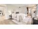Bright bedroom with light-colored walls, wood floors, and a bathroom right off the main bedroom at 19383 E Chaffee Pl, Denver, CO 80249