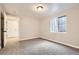 Bedroom with carpeted floors, window, and access to an additional room and closet at 19383 E Chaffee Pl, Denver, CO 80249