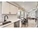 Bright kitchen with white cabinets, stainless appliances, and eat-in dining area at 19383 E Chaffee Pl, Denver, CO 80249