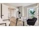 Office space with a desk, office chair, house plant, and bright view from the window at 19383 E Chaffee Pl, Denver, CO 80249