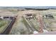 Aerial view showcasing a property with a large home, detached garage, and vast surrounding land at 220 High Meadows Loop, Elizabeth, CO 80107