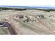 Expansive aerial view of a property highlighting the large home, outbuildings, and picturesque surroundings at 220 High Meadows Loop, Elizabeth, CO 80107
