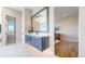 Bathroom featuring a gray vanity with modern lighting, complemented by sleek, white flooring at 220 High Meadows Loop, Elizabeth, CO 80107