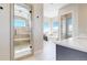 Luxurious bathroom with a glass shower and soaking tub, complemented by white tile flooring at 220 High Meadows Loop, Elizabeth, CO 80107