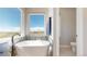 Tranquil bathroom featuring a modern, freestanding tub and scenic outdoor views at 220 High Meadows Loop, Elizabeth, CO 80107