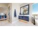 Bright bathroom with blue vanity, modern mirror, and large window with scenic views at 220 High Meadows Loop, Elizabeth, CO 80107