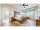 Spacious bedroom features hardwood floors, large windows, and a beautiful ceiling fan at 220 High Meadows Loop, Elizabeth, CO 80107