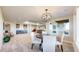 Open dining area featuring a modern light fixture, comfortable seating, and a wet bar at 220 High Meadows Loop, Elizabeth, CO 80107