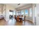 Sunlit dining room with hardwood floors, a modern chandelier, and scenic views through large windows at 220 High Meadows Loop, Elizabeth, CO 80107