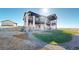 Striking two-story home with multiple balconies, stone accents, and manicured landscaping on a sunny day at 220 High Meadows Loop, Elizabeth, CO 80107
