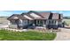 Beautiful single-Gathering home with stone accents, covered porch, and professionally landscaped front yard at 220 High Meadows Loop, Elizabeth, CO 80107