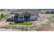 Back exterior view of a house with a lawn and multi-tiered deck and patio spaces at 220 High Meadows Loop, Elizabeth, CO 80107
