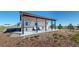 Charming covered outdoor seating area with stone accents, providing a relaxing space with scenic views at 220 High Meadows Loop, Elizabeth, CO 80107
