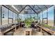 Bright greenhouse interior filled with plants, wooden shelves, and growing supplies at 220 High Meadows Loop, Elizabeth, CO 80107