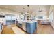 Open kitchen with a large island and stainless steel appliances seamlessly integrates with the inviting living space and fireplace at 220 High Meadows Loop, Elizabeth, CO 80107