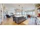 Gourmet kitchen showcases a large island with a sink, modern appliances, and an open layout connecting to the living area at 220 High Meadows Loop, Elizabeth, CO 80107