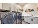 Laundry room features stainless steel washer and dryer, and stylish patterned flooring at 220 High Meadows Loop, Elizabeth, CO 80107