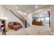 Open-concept living room featuring a staircase, plush seating, and cozy fireplace with scenic views at 220 High Meadows Loop, Elizabeth, CO 80107