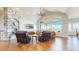 Bright living room with a stone fireplace, hardwood floors, and large windows with scenic views at 220 High Meadows Loop, Elizabeth, CO 80107