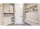 Mud room with white cabinets, bench seating, and stylish patterned flooring at 220 High Meadows Loop, Elizabeth, CO 80107
