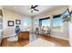Well-lit home office boasts a large desk, comfortable seating, and expansive windows showcasing beautiful outdoor views at 220 High Meadows Loop, Elizabeth, CO 80107