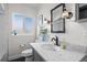 Bathroom with a marble countertop, and black hardware fixtures at 3083 Ash St, Denver, CO 80207