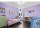 Bedroom with lavender walls, hardwood floors, and a bay window at 3083 Ash St, Denver, CO 80207